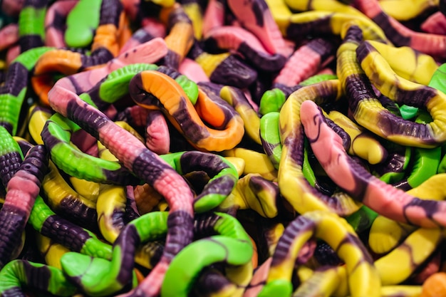 Candy background chewing jelly candies in the form of worms closeup