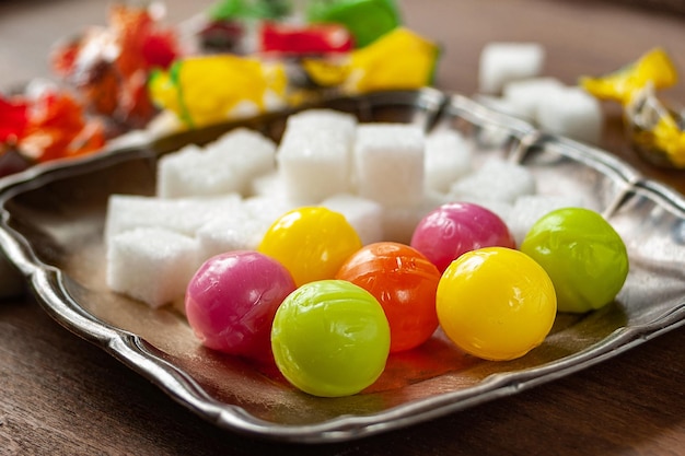 Candy balls and pieces of sugar Colored dragees hard fruit candy and sugar stacked