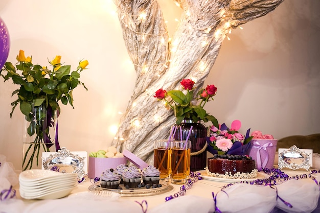 Candy bar decorated by delicious sweet buffet with cupcakes and other dessertscandieshappy birthday concept