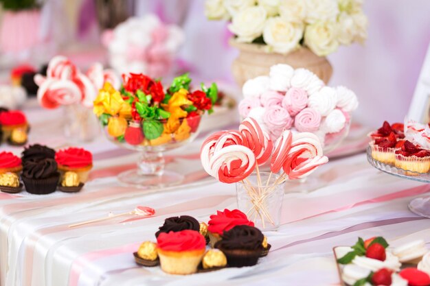 Candy Bar Delicious sweet buffet with cupcakes Sweet holiday buffet with cupcakes and other dessertsTable with sweets candies dessert