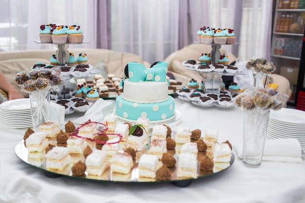 Candy Bar Delicious sweet buffet with cupcakes Sweet holiday buffet with cupcakes and other dessertsTable with sweets candies desserthappy birthday concept