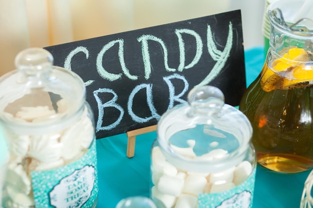 Candy bar on wedding ceremony with a lot of different candies and beverages