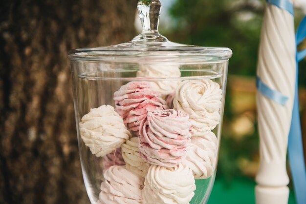 Candy bar for your birthday. Children's party in the nature. Airy white and pink marshmallow