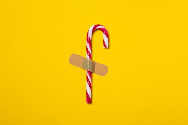 candy cane plastered to the yellow background