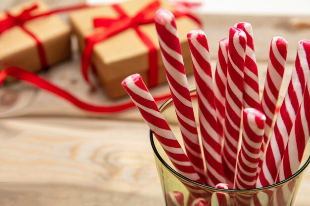 Candy canes in a glass wooden background