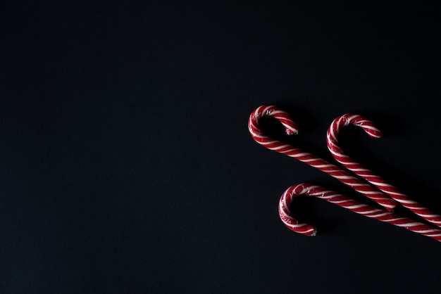 Candy canes on gray stone background. Close up