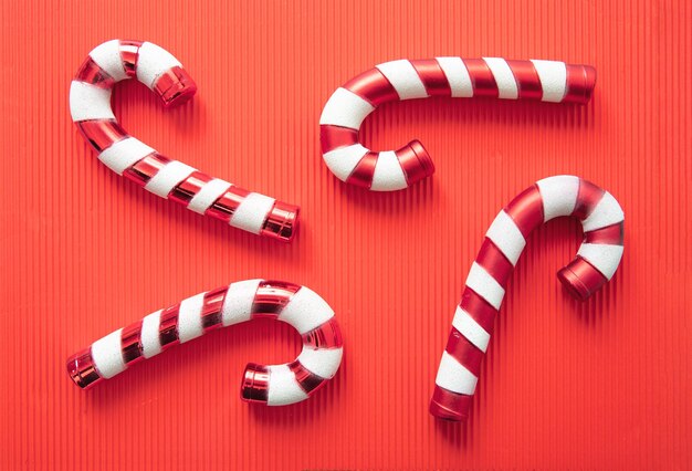 Candy canes on red background christmas traditional red white\
striped candies