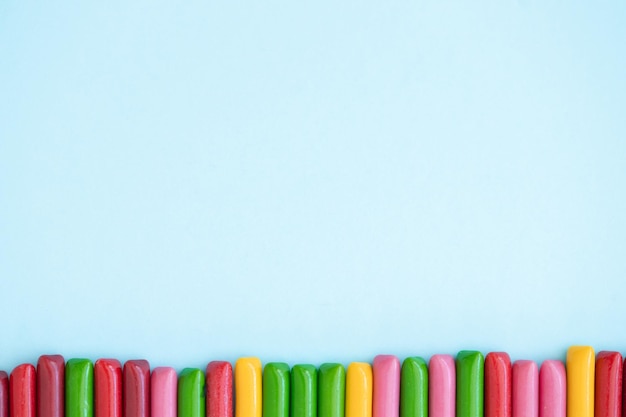 Candy colored sticks on blue background