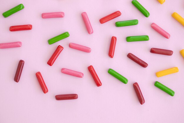 Candy colored sticks on pink background