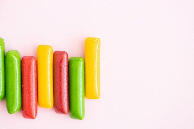 Candy colored sticks on pink background