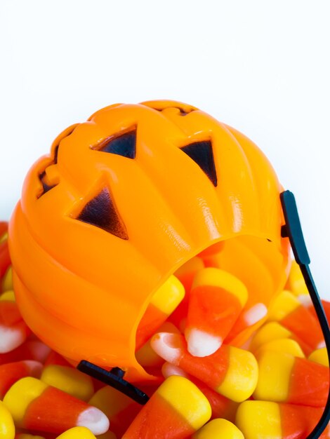 Candy corn candies falling out of halloween treat bag