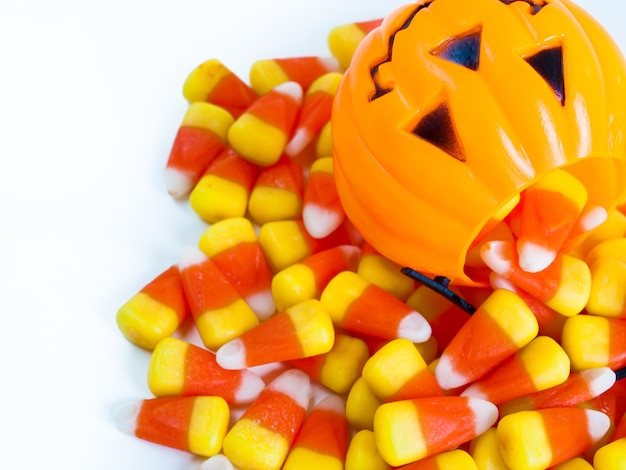 Candy corn candies falling out of Halloween treat bag.