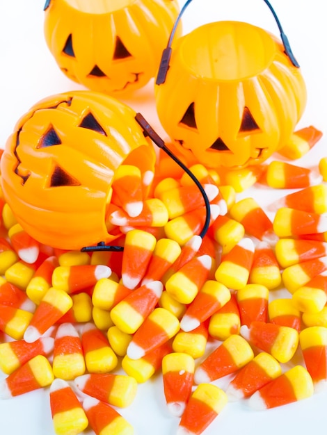 Photo candy corn candies falling out of halloween treat bag.