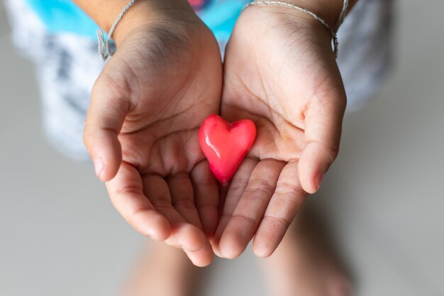 Candy red heart in hand a boy.