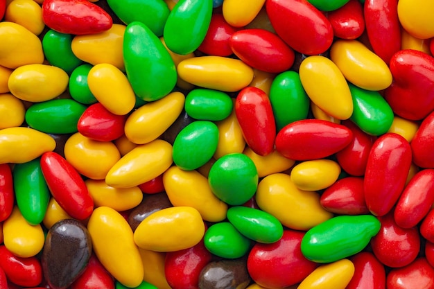 Candy seeds in multi colored sweet glaze in bulk closeup wallpaper background full depth of fieldxD