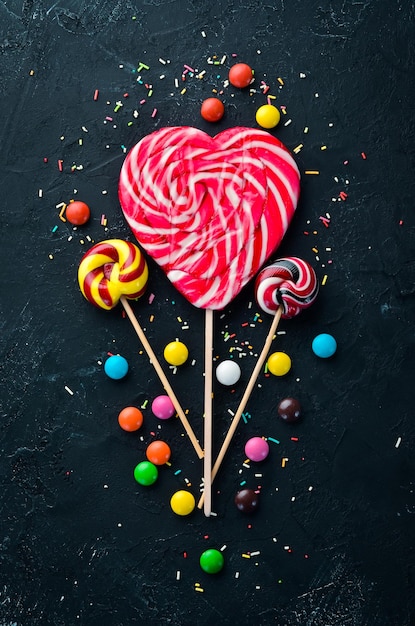 Candy on a stick in the form of a heart Top view free copying space