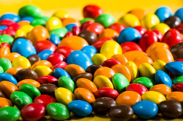 Candy on the yellow background colorful candy and multicolored gradient