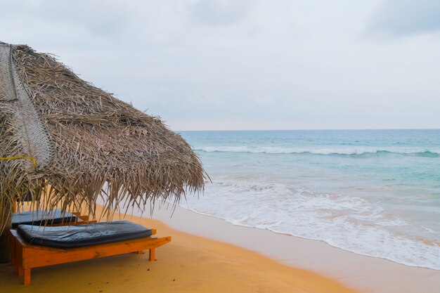 Cane umbrella on the beach in the ocean