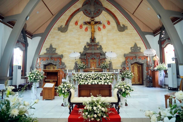 canggu bali indonesia september 28 2023 balinese catholic church interior with wedding flowers decoration in white bali church indoor architecture with local culture style