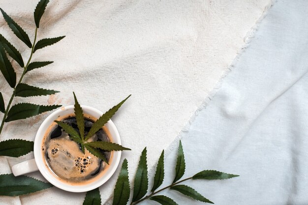 Cannabis coffee put on linen fabric. top view