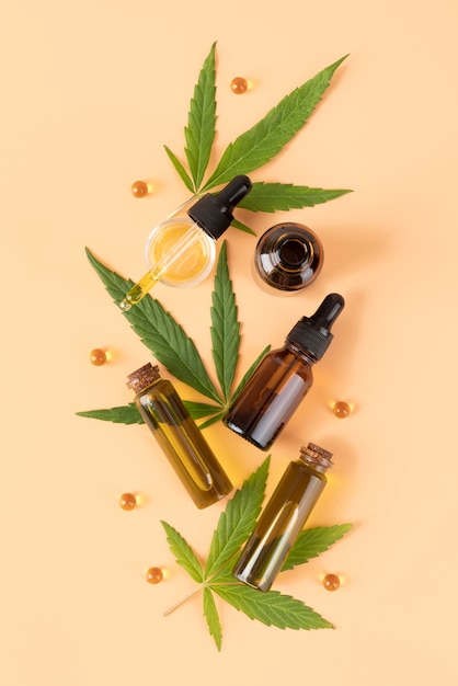 Photo cannabis leaf and oil bottle arrangement