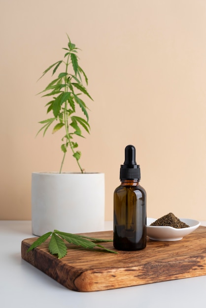 Photo cannabis leaf and oil bottle composition