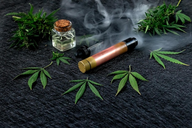 Жидкий каннабис Vape CBD или THC Vaping Марихуана и конопля на темном фоне Густой пар