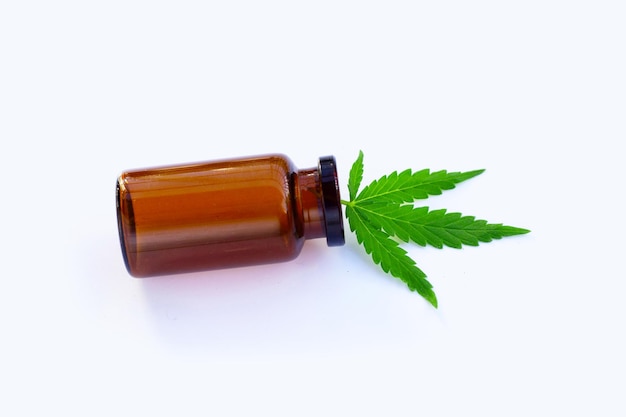 Cannabis plant Fresh green leaf with brown bottle on white background