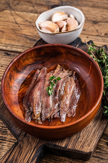 Canned Anchovies fish fillet in a wooden bowl