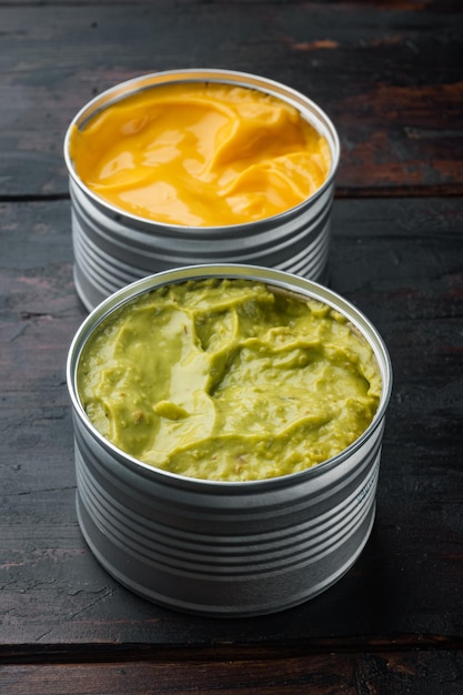 Canned cheese and guacamole  sauce in can, on old wooden table