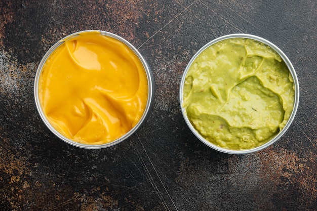 Canned cheese and guacamole  sauce in can, top view or flat lay