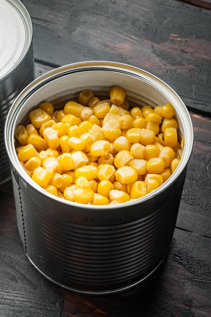 Canned corn in can on old dark wooden table background