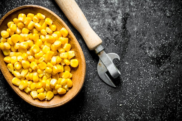 Canned corn on a plate with a can opener