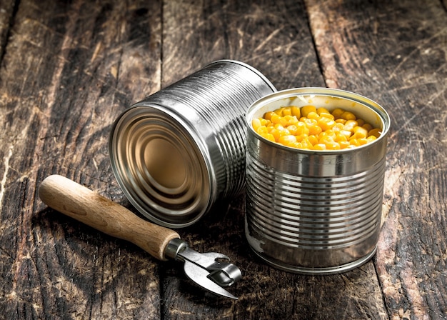 Canned corn in a tin can with opener. 