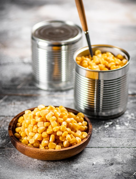 Canned corn on a wooden plate