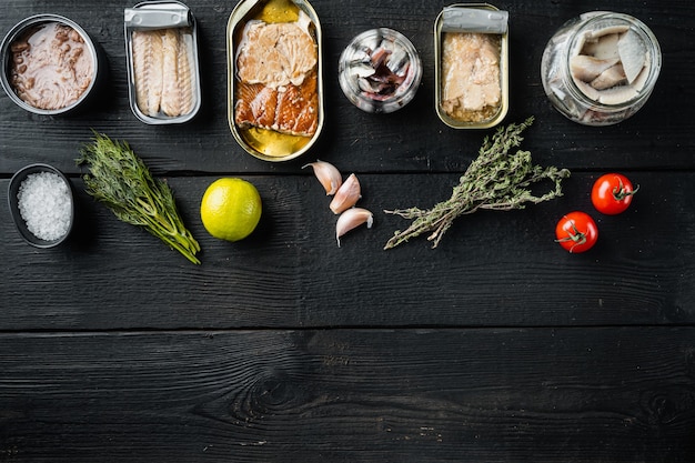 Canned fish with different assortment types of seafood set, on black wooden table