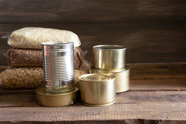Canned food and food on a dark wooden table