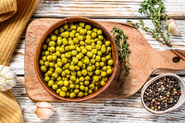 Canned green peas in a wooden bowl