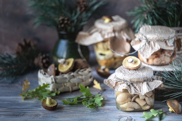 Canned mushrooms in a glass jar on the table