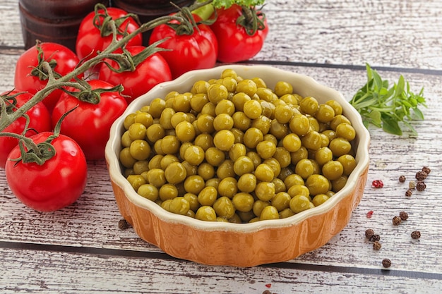 Canned sweet green peas conserve in the bowl