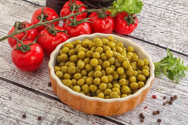 Canned sweet green peas conserve in the bowl