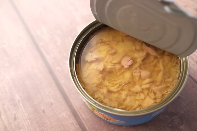 Canned tuna on wooden table