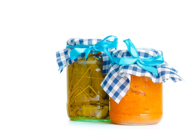 Canned vegetables in glass jars isolated on white 