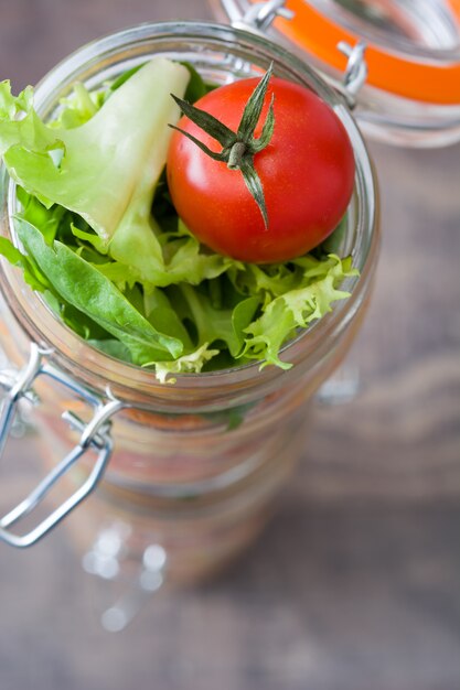 Canned vegetables in transparent glass jar