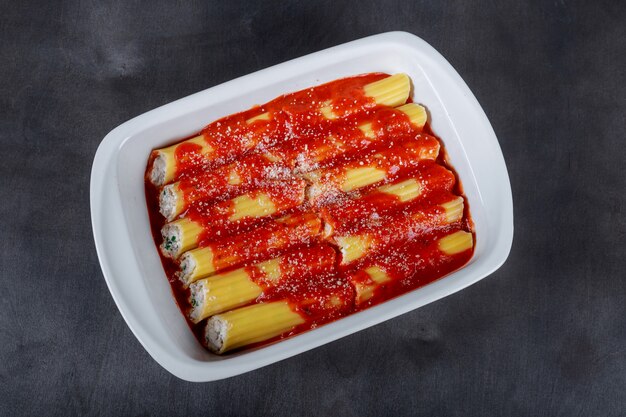 Cannelloni on a plate with meat and tomato sauce