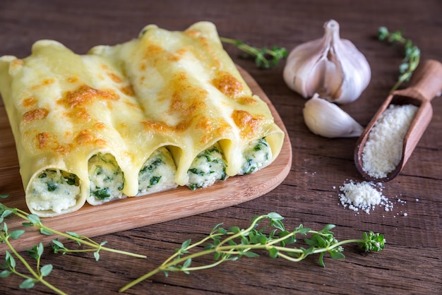 Cannelloni with ricotta and spinach on wooden board