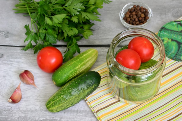 canning of tomatoes and cucumbers in jars for winter