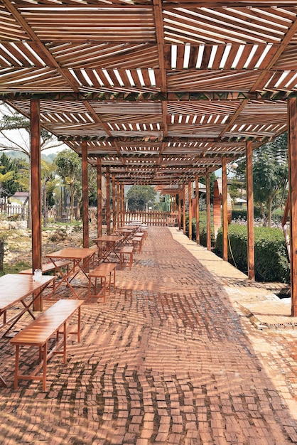 Canopy from the rain with wooden tables and chairs in the city of Da Lat in the mountains of Vietnam