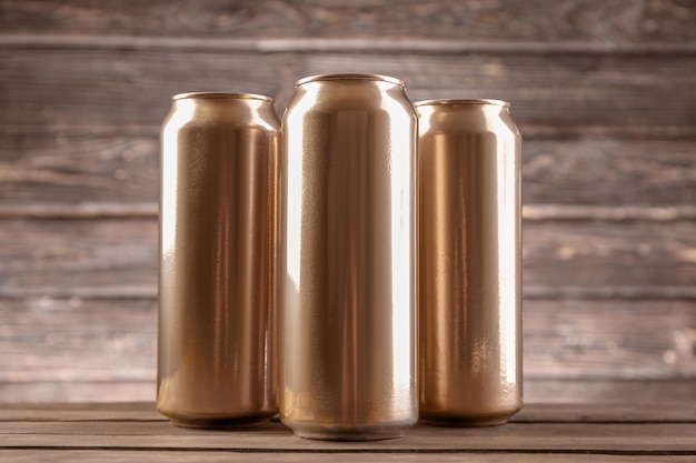 Cans of beer on wooden background