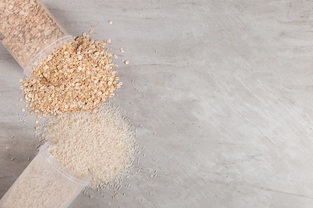 Cans of rice and oatmeal are scattered on the table.